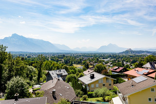 Aussicht Richtung Berge, Bäume und ein Wohngebiet